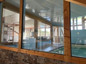 a house with a swimming pool and windows at Traumscheune mit Pool, Kamin und privatem Spa in Linnich