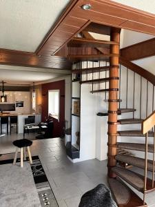 a living room with a spiral staircase in a house at Traumscheune mit Pool, Kamin und privatem Spa in Linnich