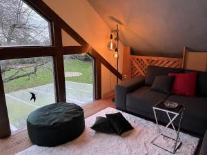 a living room with a couch and a large window at Traumscheune mit Pool, Kamin und privatem Spa in Linnich