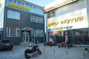 una motocicleta estacionada frente a un edificio en Hotel Albatros, en Irkutsk