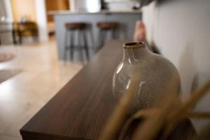 a glass vase sitting on top of a wooden table at Pet Friendly! Private retreat in Nob Hill in Albuquerque