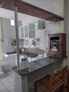 a kitchen with a counter top with a stove top oven at Casa de Maria Suítes in Recife