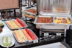 a buffet line with many different types of food at Pousada Terra do Sol Natal in Natal