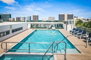 a swimming pool on top of a building with a city skyline at Bay Harbor One Vacation in Miami Beach