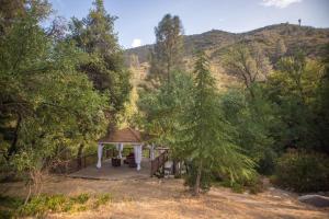 a gazebo in the middle of a forest at Quiet Mind Lodge, Spa & Retreat Sequoias in Kernville