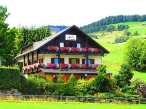 a house with flowers on the side of it at Pension Lambrecht in Sankt Lambrecht