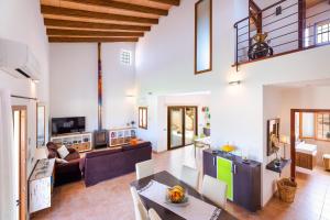 a living room with a couch and a table at YupiHome Finca Can Soler in Inca