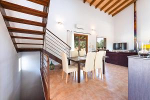 a dining room with a table and chairs at YupiHome Finca Can Soler in Inca