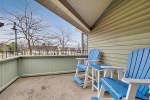 two blue and white chairs on a porch at 212 Pointes North Inn in Charlevoix