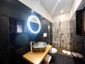 a bathroom with a bowl sink and a mirror at Hotel Cittadella in Locarno