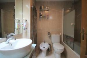a bathroom with a white sink and a toilet at Casa Rincón de Broto in Broto