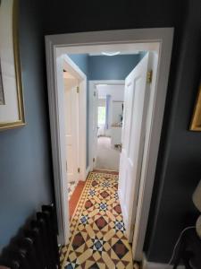 a hallway with a tile floor in a house at Dunagree Bed & Breakfast in Greencastle