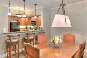 a kitchen with a wooden table and chairs at RiverStone Condo Resort & Spa in Pigeon Forge