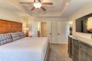 a bedroom with a bed and a flat screen tv at RiverStone Condo Resort & Spa in Pigeon Forge