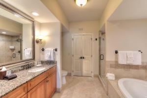 a bathroom with a tub and a toilet and a sink at RiverStone Condo Resort & Spa in Pigeon Forge