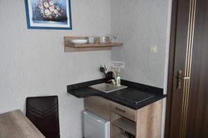 a bathroom with a sink and a mirror at Pokoje Gościnne Katarzyna Kur in Dębki