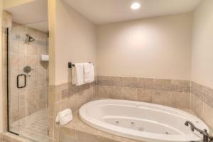 a bathroom with a large tub and a shower at RiverStone Condo Resort & Spa in Pigeon Forge