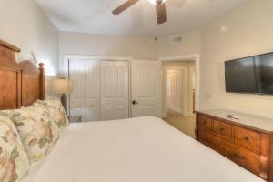 a bedroom with a bed and a flat screen tv at RiverStone Condo Resort & Spa in Pigeon Forge