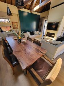 a living room with a wooden table and a couch at Selin the stone house in Limassol