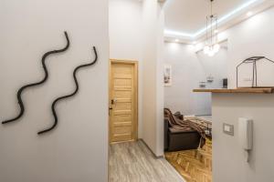 a living room with a black snake sculpture on the wall at SemmiHome Budapest Semmelweis Street in Budapest