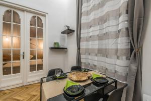 a dining room with a table with a plate on it at SemmiHome Budapest Semmelweis Street in Budapest