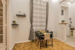 a small dining room with a table and chairs at SemmiHome Budapest Semmelweis Street in Budapest
