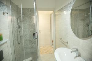 a bathroom with a sink and a shower and a sink at Sweet House Taormina in Taormina +30 photos