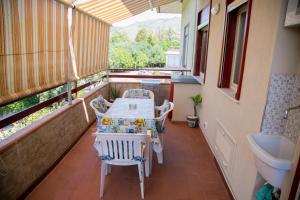 a balcony with a table and chairs and a sink at Sweet House Taormina in Taormina