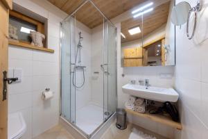 a bathroom with a glass shower and a sink at Appartementhaus Anka in Seefeld in Tirol