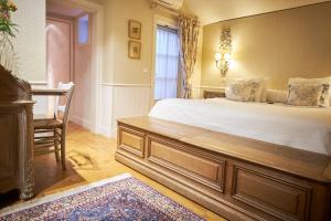 a bedroom with a large bed and a large mirror at Relais Bourgondisch Cruyce, A Luxe Worldwide Hotel in Bruges