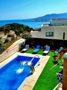 a swimming pool on the side of a house at MIRADOR DEL CERRADO DE LUJO free parking in Málaga