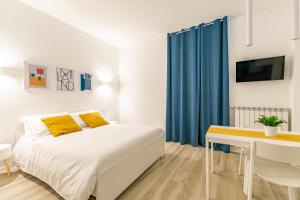 a bedroom with a bed and a desk and a tv at Casa di Sophy in Milan