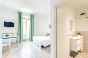 a bedroom with a bed and a desk and a sink at Casa di Sophy in Milan