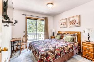 a bedroom with a bed and a desk and a window at Sundial on Deck in Sunriver +30 photos