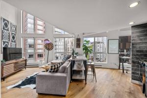 a living room with a couch and a table at Beautiful Downtown Loft with full kitchen in Vancouver