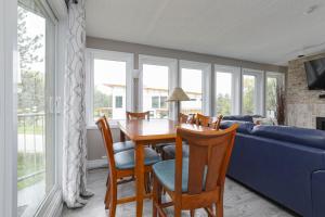 Una sala de estar con una mesa y sillas y un sofá azul. en Condo at Blue Mountain on Ski Run Close to Village, en Blue Mountains