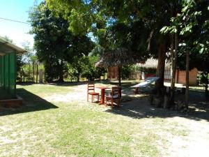 a picnic table and a playground in a park at Albertico Jungle House in Pucallpa