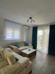 a living room with a couch and a table at Apartman Holiday in Tivat