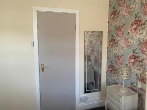 a room with a white door and a mirror at The Hurstmere in Blackpool +47 photos
