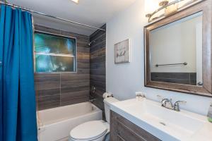 a bathroom with a sink toilet and a mirror at Modern Riverview Apartments in Fort Lauderdale