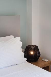 a bedroom with a bed with a lamp on a table at chris apartement in Nydri