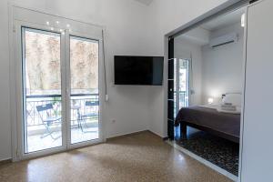 a bedroom with a bed and a sliding glass door at Fantastic location who love sea and center in Athens