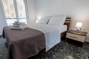 a bedroom with a bed with white sheets and pillows at Fantastic location who love sea and center in Athens