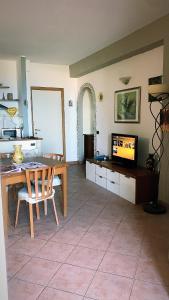 a living room with a table and a television at RedHouse in Crotone