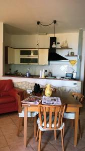 a kitchen with a table and chairs in a room at RedHouse in Crotone