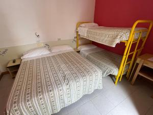 Postel nebo postele na pokoji v ubytování HOTEL ZUCCONI