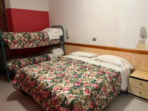 Postel nebo postele na pokoji v ubytování HOTEL ZUCCONI