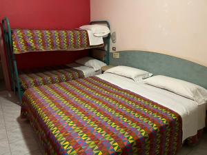 Postel nebo postele na pokoji v ubytování HOTEL ZUCCONI