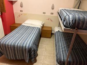 Postel nebo postele na pokoji v ubytování HOTEL ZUCCONI