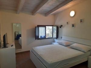 Ένα ή περισσότερα κρεβάτια σε δωμάτιο στο Villetta del Poggio
